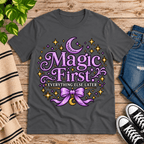 Magic First cute celestial graphic t-shirt cozy flat lay in asphalt.