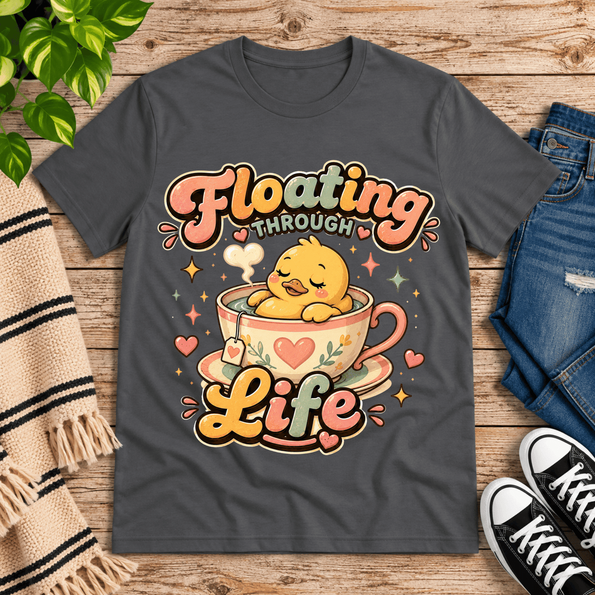 Floating Through Life cute animal graphic t-shirt cozy flat lay in asphalt.