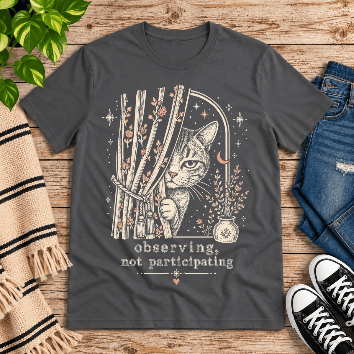Cat Observing cute animal graphic t-shirt cozy flat lay in asphalt.