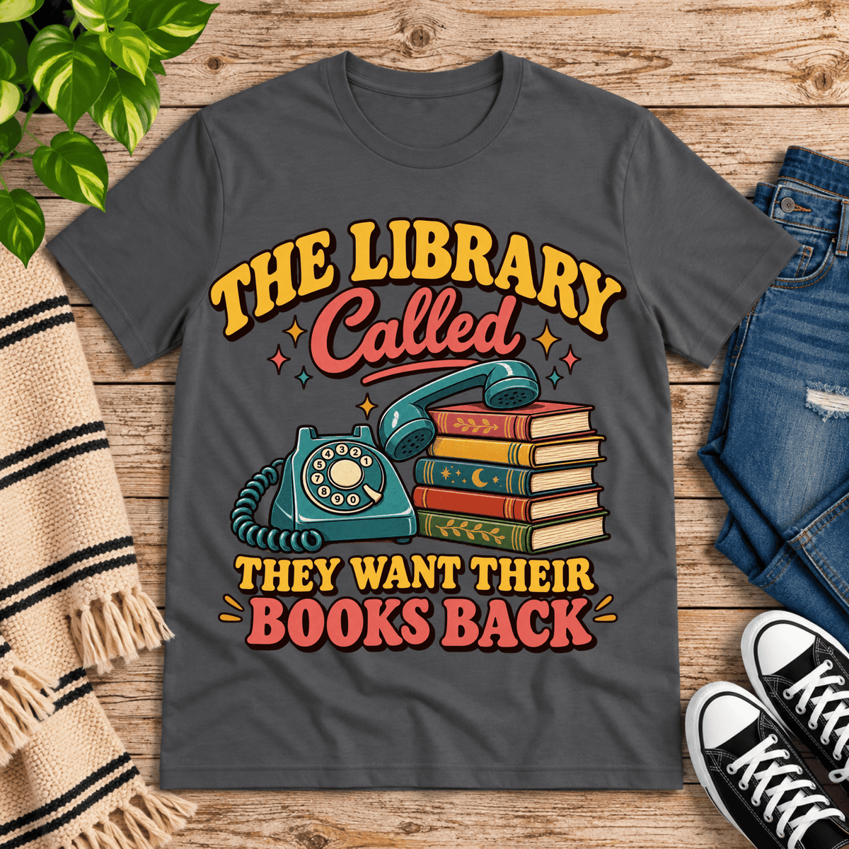 The Library Called book lovers graphic t-shirt cozy flat lay in asphalt.