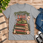 Protecting My TBR cute book graphic t-shirt cozy flat lay in athletic heather.