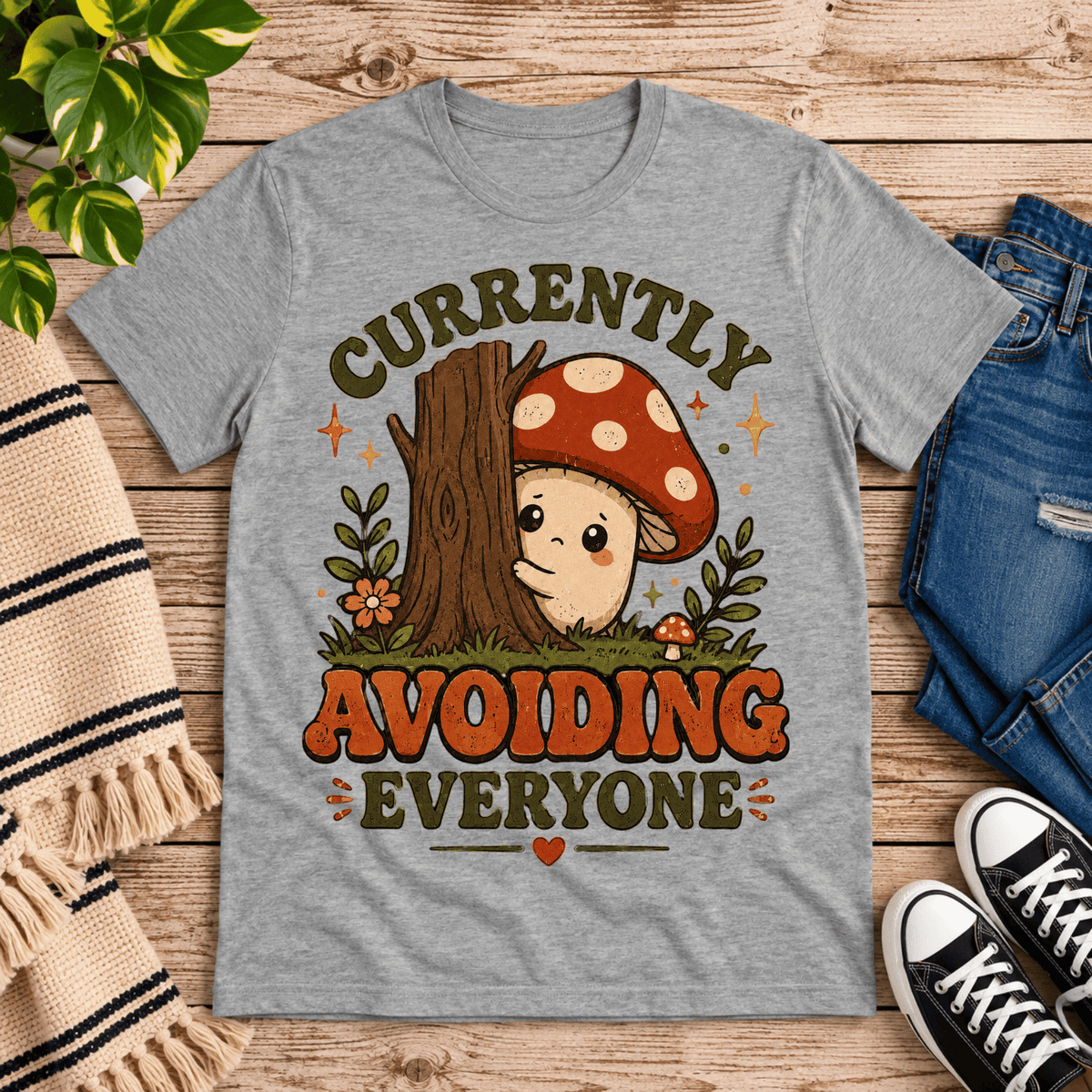 Currently Avoiding funny cottagecore graphic t-shirt cozy flat lay in athletic heather.