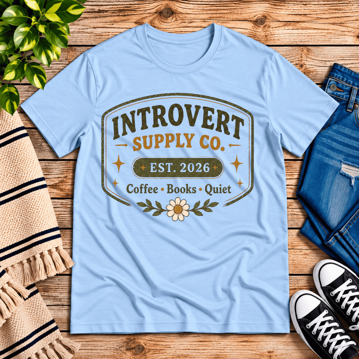 Introvert Supply Co. cute introvert graphic t-shirt cozy flat lay in baby blue.