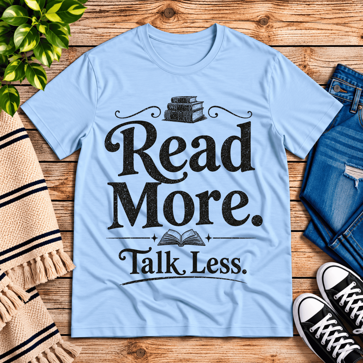 Talk Less funny book graphic t-shirt cozy flat lay in baby blue.
