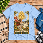 The Sun tarot card mystical graphic t-shirt cozy flat lay in baby blue.