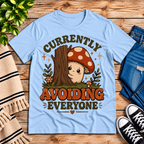 Currently Avoiding funny cottagecore graphic t-shirt cozy flat lay in baby blue.