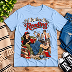 A cozy flat lay mockup of I'd Rather Be retro book graphic t-shirt in baby blue.