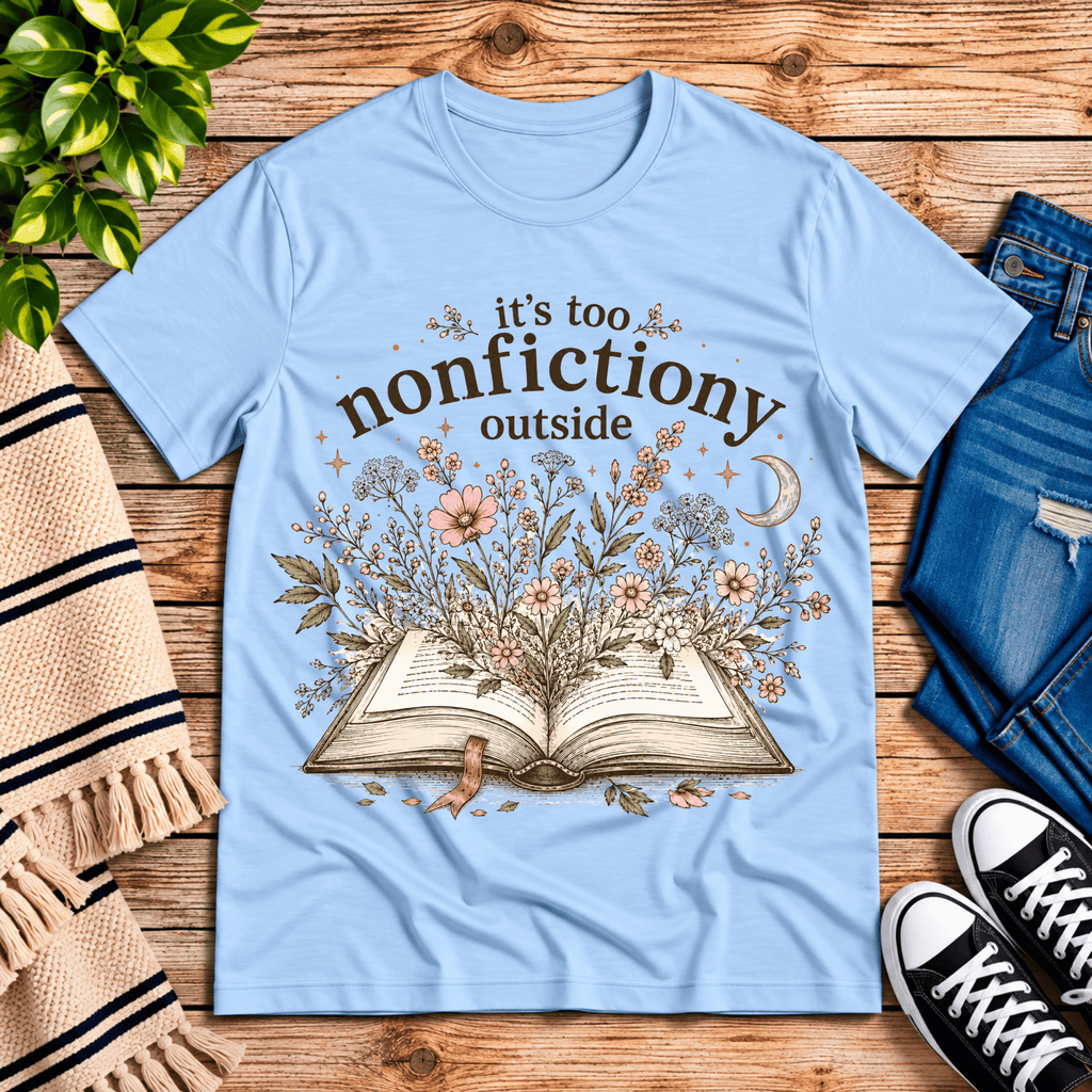Nonfictiony whimsical book graphic t-shirt cozy flat lay in baby blue.