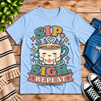 Sip. Sigh. Repeat. coffee graphic t-shirt cozy flat lay in baby blue.