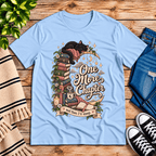 One More Chapter cute book graphic t-shirt cozy flat lay in baby blue.