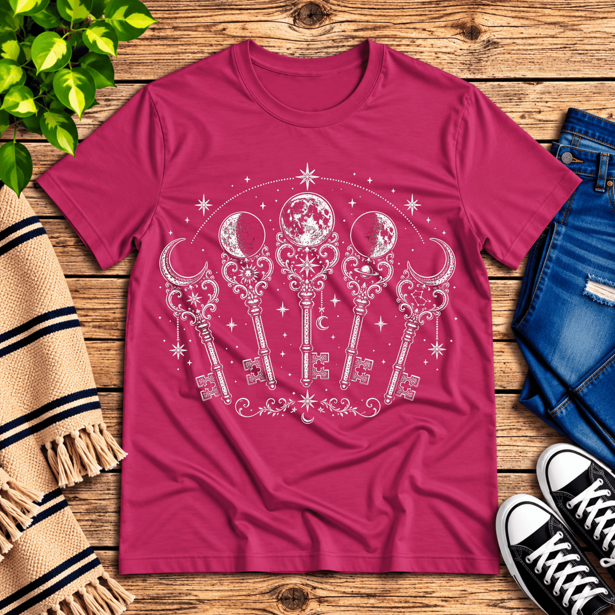 Moon Phase Keys celestial graphic t-shirt cozy flat lay in charity pink.