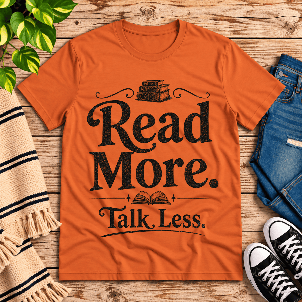 Talk Less funny book graphic t-shirt cozy flat lay in burnt orange.