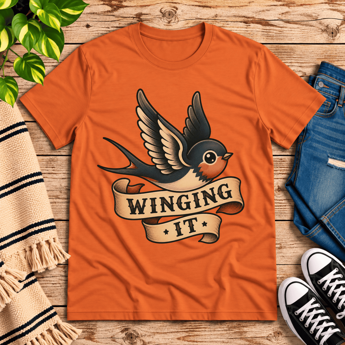 Winging It cute animal graphic t-shirt cozy flat lay in burnt orange.