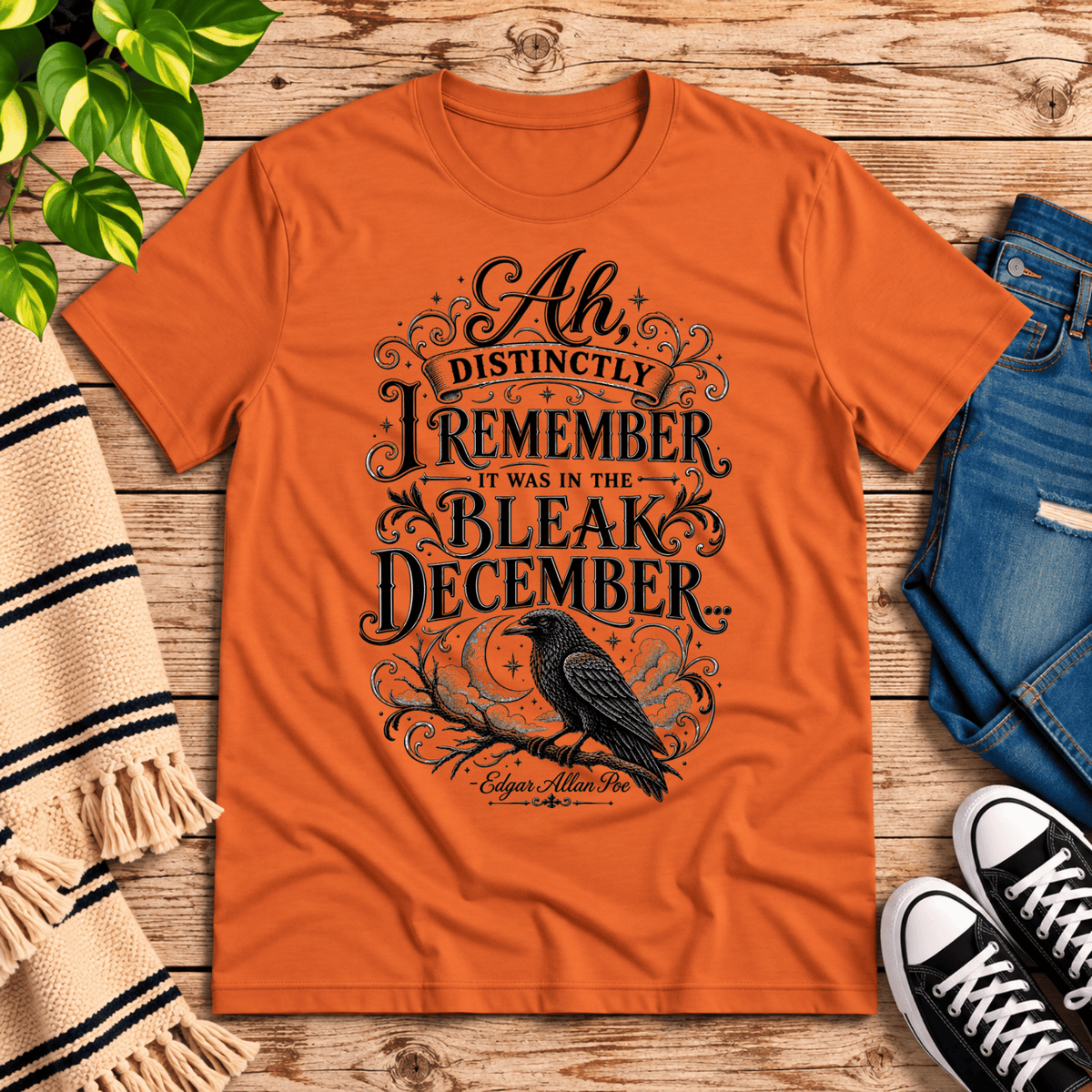 Bleak December book quote graphic t-shirt cozy flat lay in burnt orange.