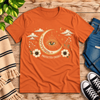 Protected Energy celestial mystic graphic t-shirt cozy flat lay in burnt orange.