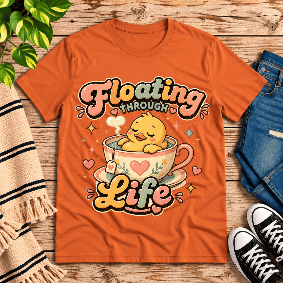 Floating Through Life cute animal graphic t-shirt cozy flat lay in burnt orange.
