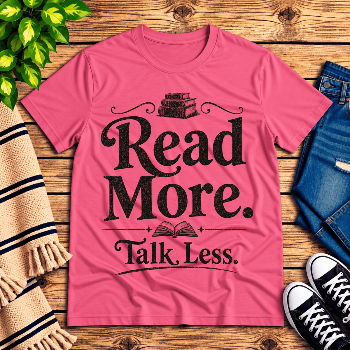 Talk Less funny book graphic t-shirt cozy flat lay in charity pink.