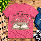 Nonfictiony whimsical book graphic t-shirt cozy flat lay in charity pink.