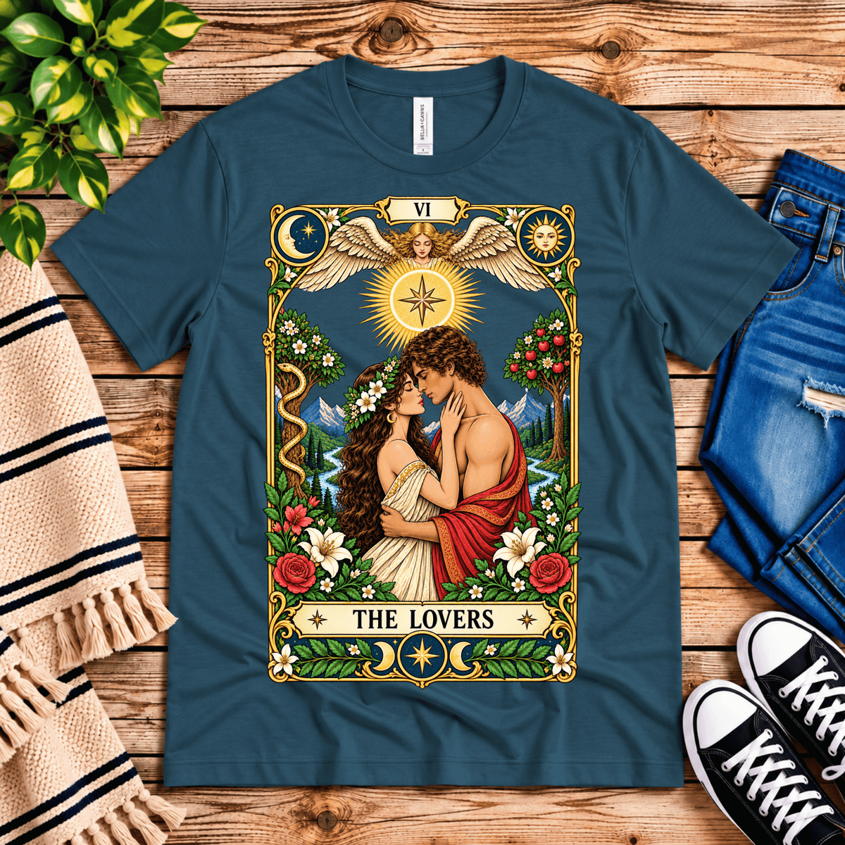 The Lovers tarot card graphic t-shirt cozy flat lay in deep teal.