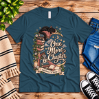 One More Chapter cute book graphic t-shirt cozy flat lay in deep teal.