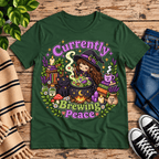 Currently Brewing cute witchy graphic t-shirt cozy flat lay in evergreen.