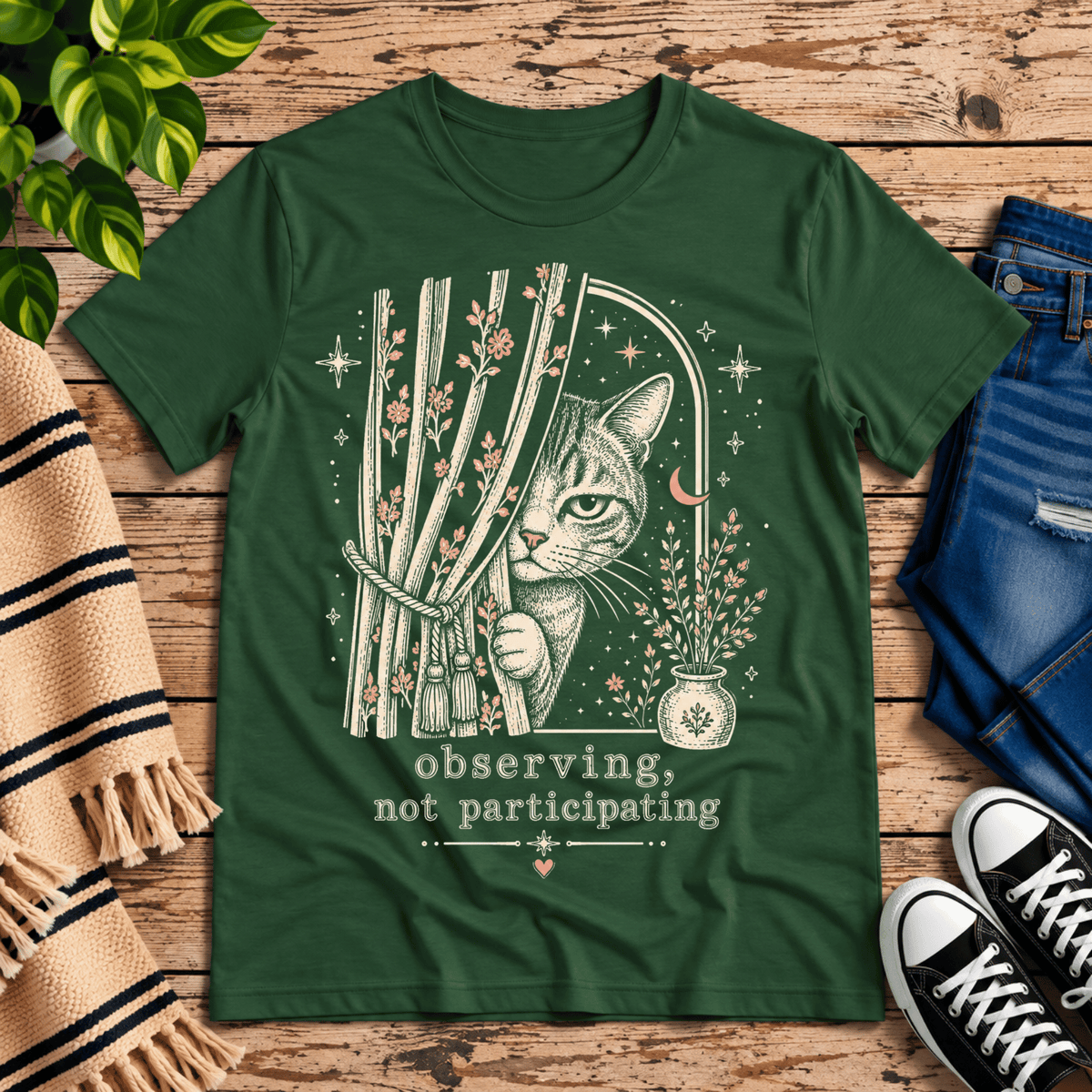 Cat Observing cute animal graphic t-shirt cozy flat lay in evergreen.