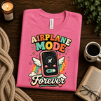 A folded mockup of Airplane Mode funny introvert graphic t-shirt in charity pink.