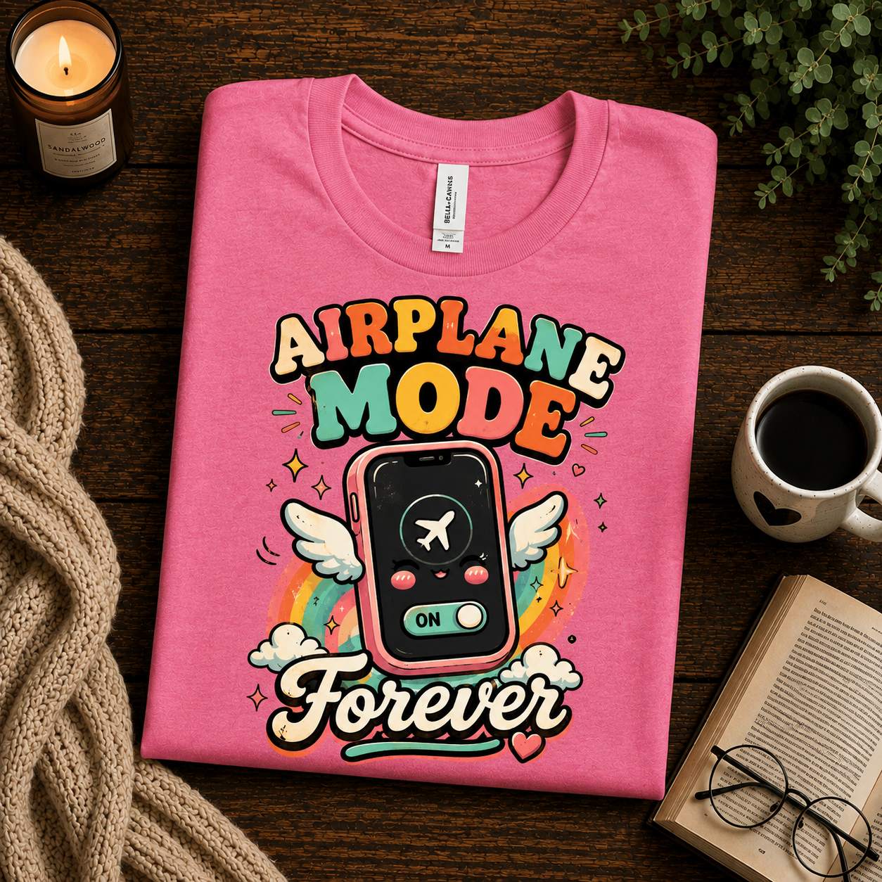A folded mockup of Airplane Mode funny introvert graphic t-shirt in charity pink.