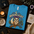 A folded mockup of Moonlight Society cute celestial graphic t-shirt in aqua.