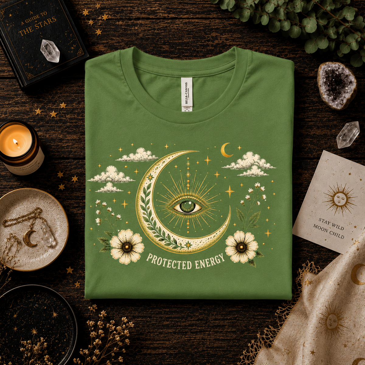 A folded mockup of Protected Energy mystical celestial  graphic t-shirt in leaf.