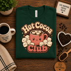 A folded mockup of Hot Cocoa Club graphic t-shirt in evergreen.