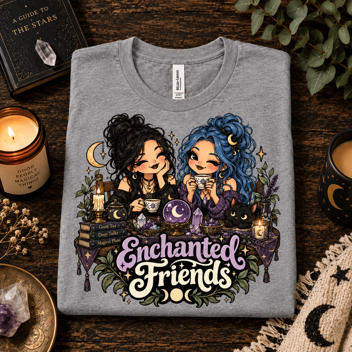 A folded mockup of Enchanted Friends cute celestial graphic t-shirt in athletic heather.