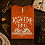 A folded mockup of Reading Since funny book graphic t-shirt in burnt orange.