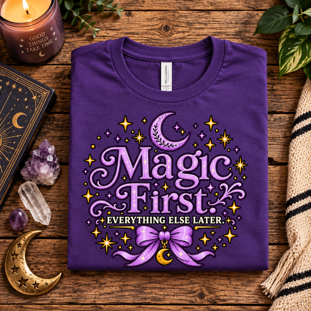 A folded mockup of Magic First whimsical celestial graphic t-shirt in team purple.
