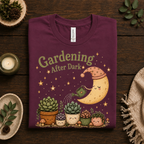 A folded mockup of Gardening After Dark nature lover graphic t-shirt in maroon.