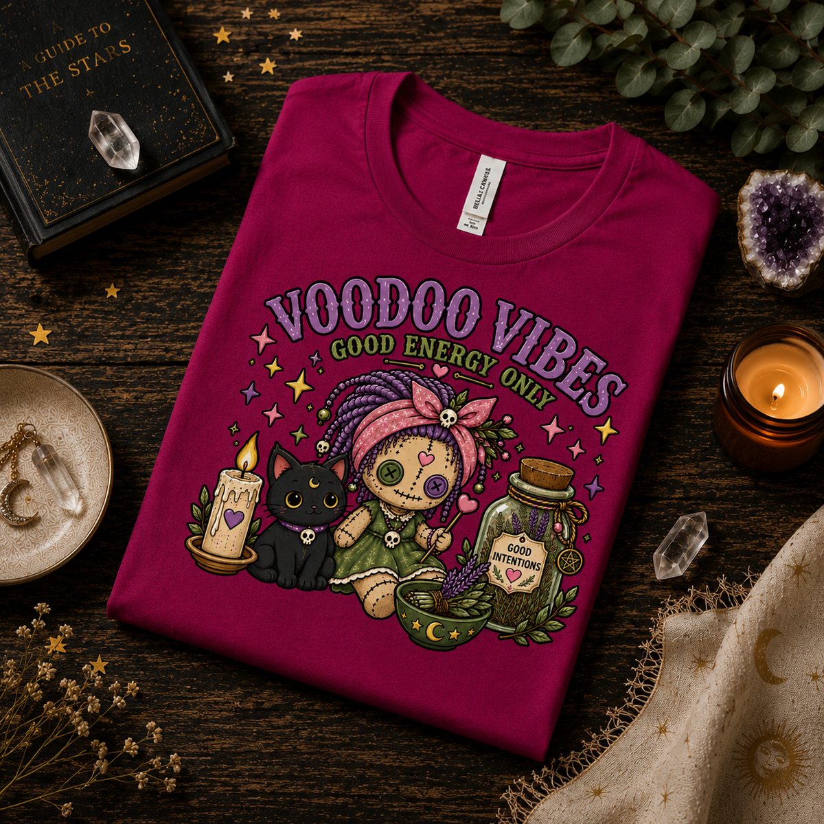 A folded mockup of Voodoo Vibes cute magical graphic t-shirt in berry.