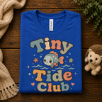 A folded mockup of Tiny Tide Club cute animal graphic t-shirt in true royal.