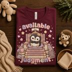 A folded mockup of Available For Judgement graphic t-shirt in maroon.