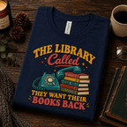 A folded mockup of The Library Called book lovers graphic t-shirt in navy.