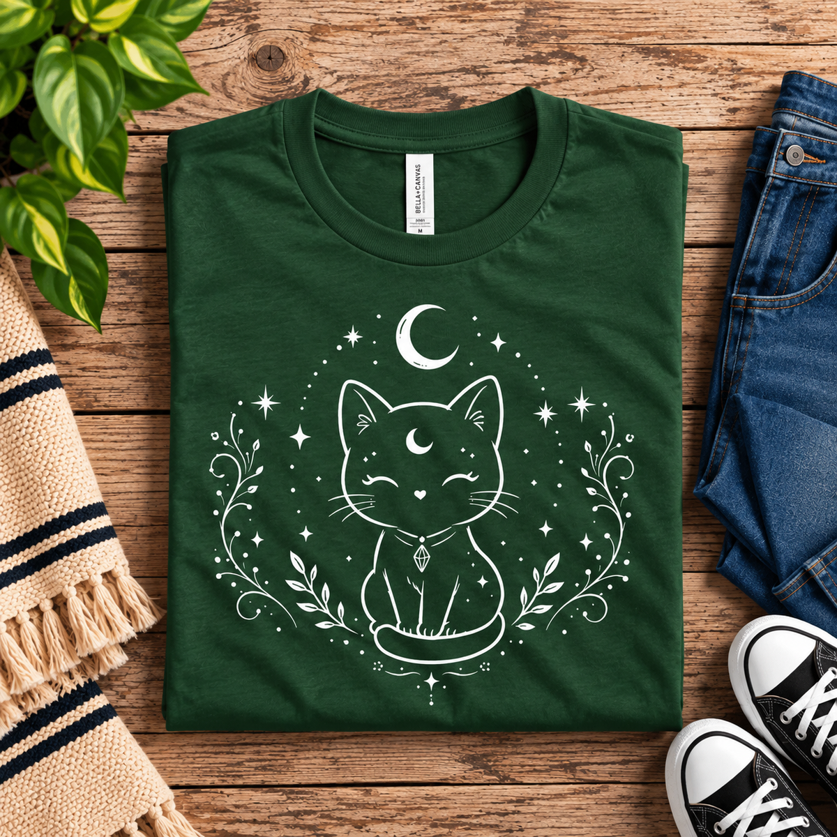 A folded mockup of Mystical Cat cute celestial graphic t-shirt in evergreen.