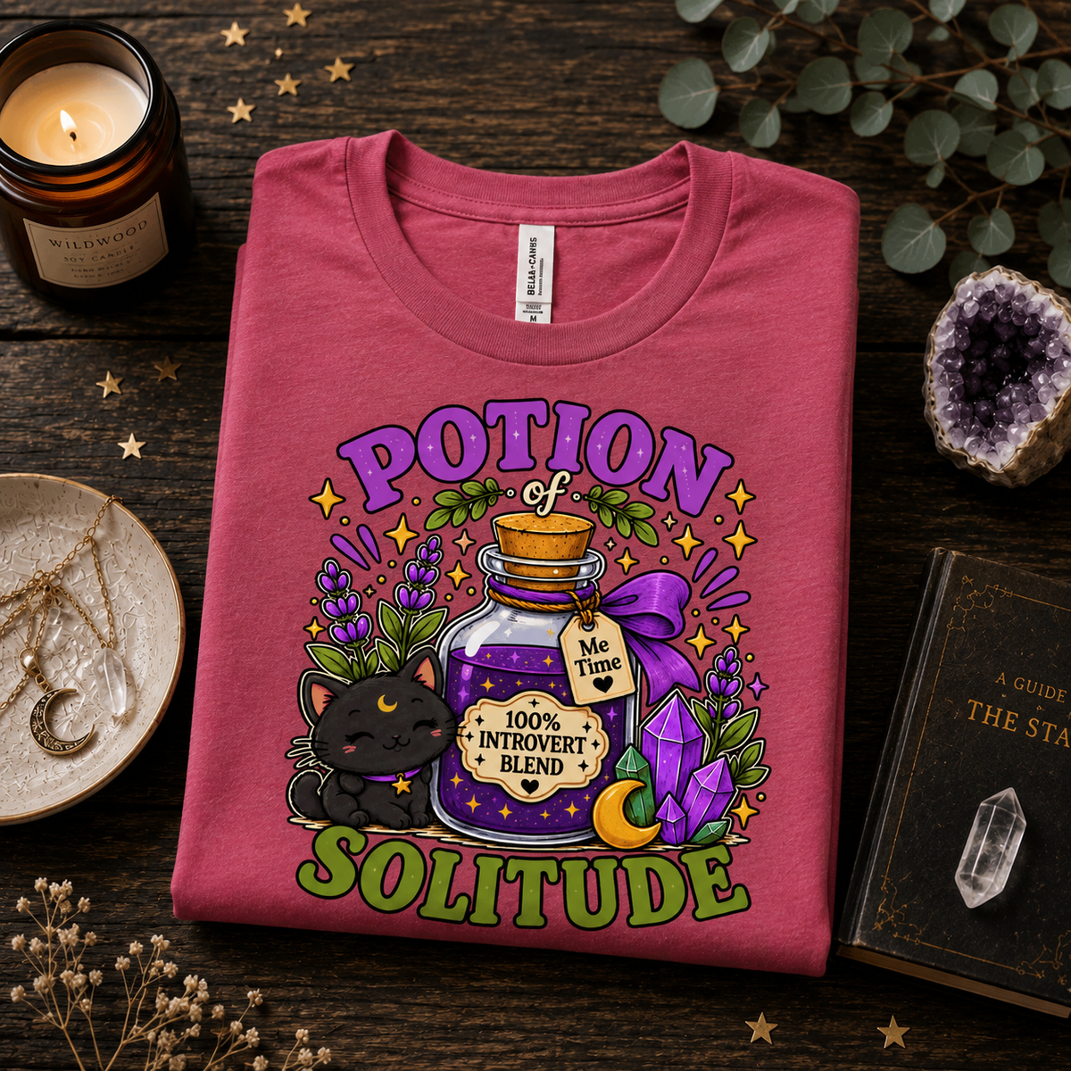 A folded mockup of Potion Of Solitude cute witchy graphic t-shirt in charity pink.