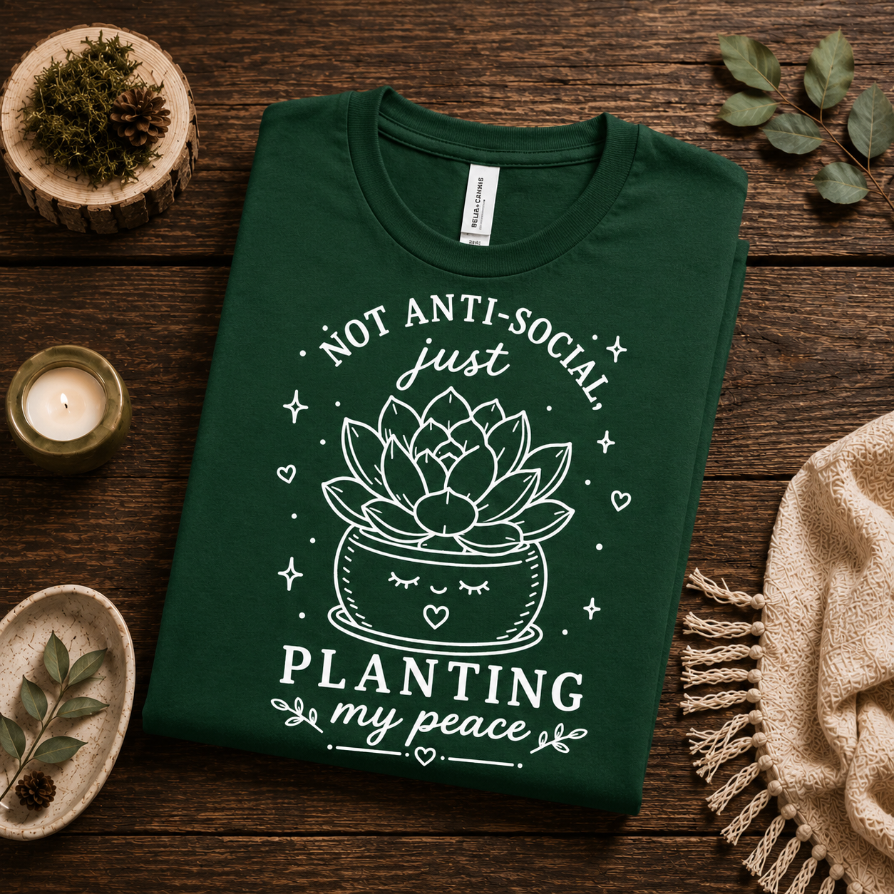 A folded mockup of Planting My Peace cute plant graphic t-shirt in evergreen.