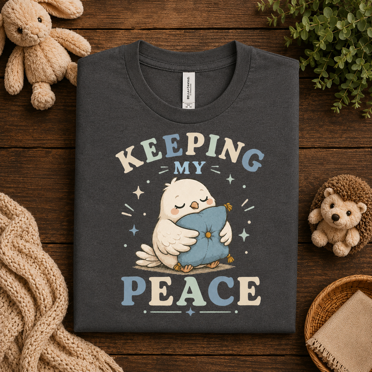 A folded mockup of Keeping My Peace cute animal graphic t-shirt in asphalt.