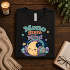 A folded mockup of Mono State Of Mind funny introvert graphic t-shirt in vintage black.