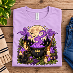 A folded mockup of The Cauldron cute celestial graphic t-shirt in lilac.