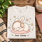 A folded mockup of Low Noise Bunny cute animal graphic t-shirt in vintage white.