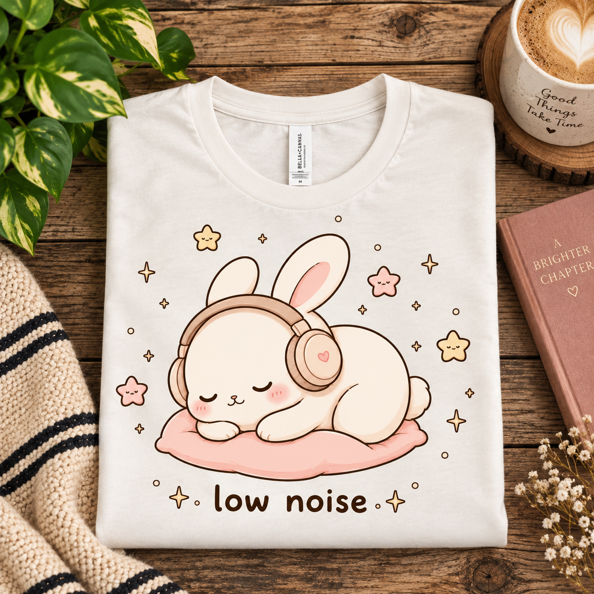 A folded mockup of Low Noise Bunny cute animal graphic t-shirt in vintage white.