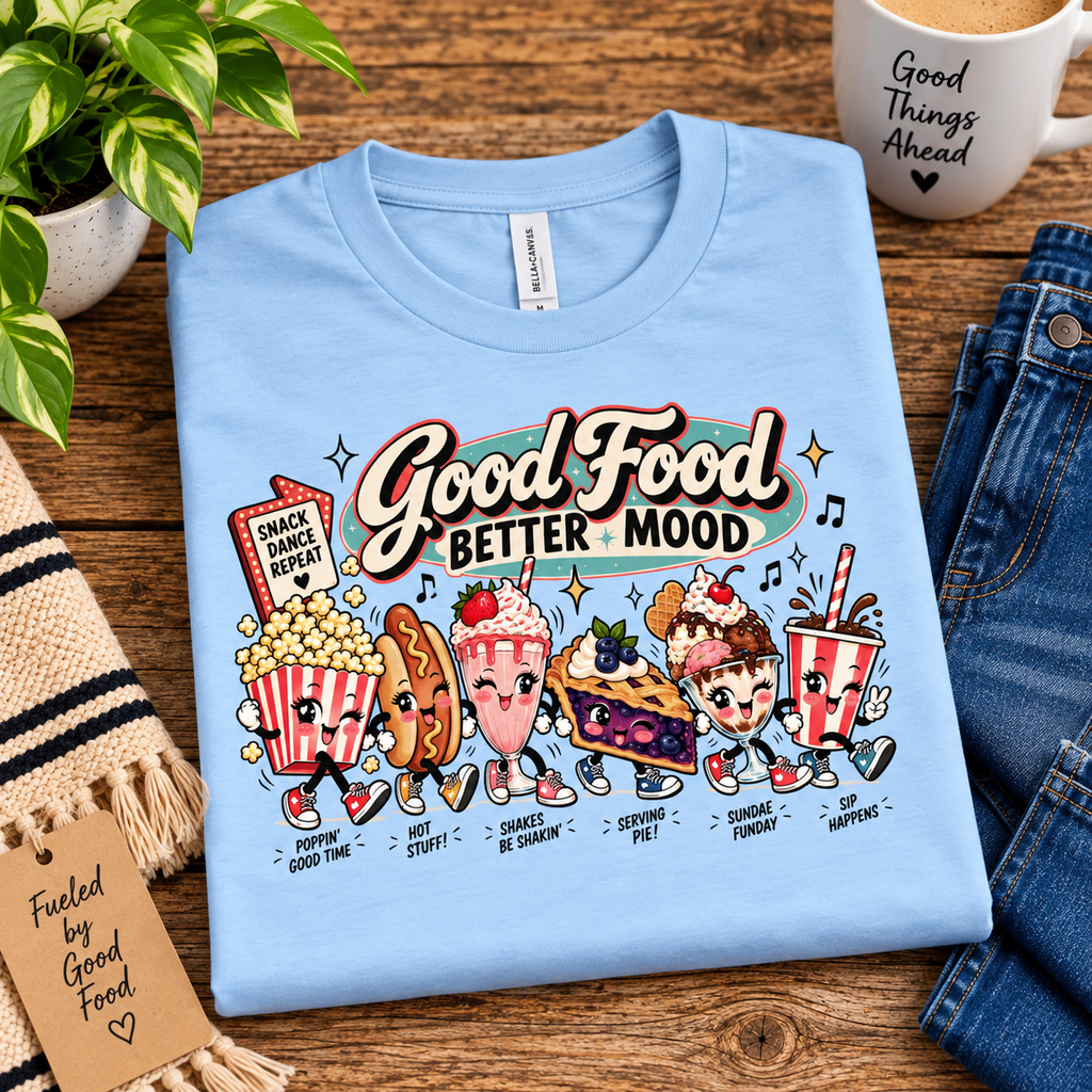 A folded mockup Good Food retro food graphic t-shirt in baby blue.