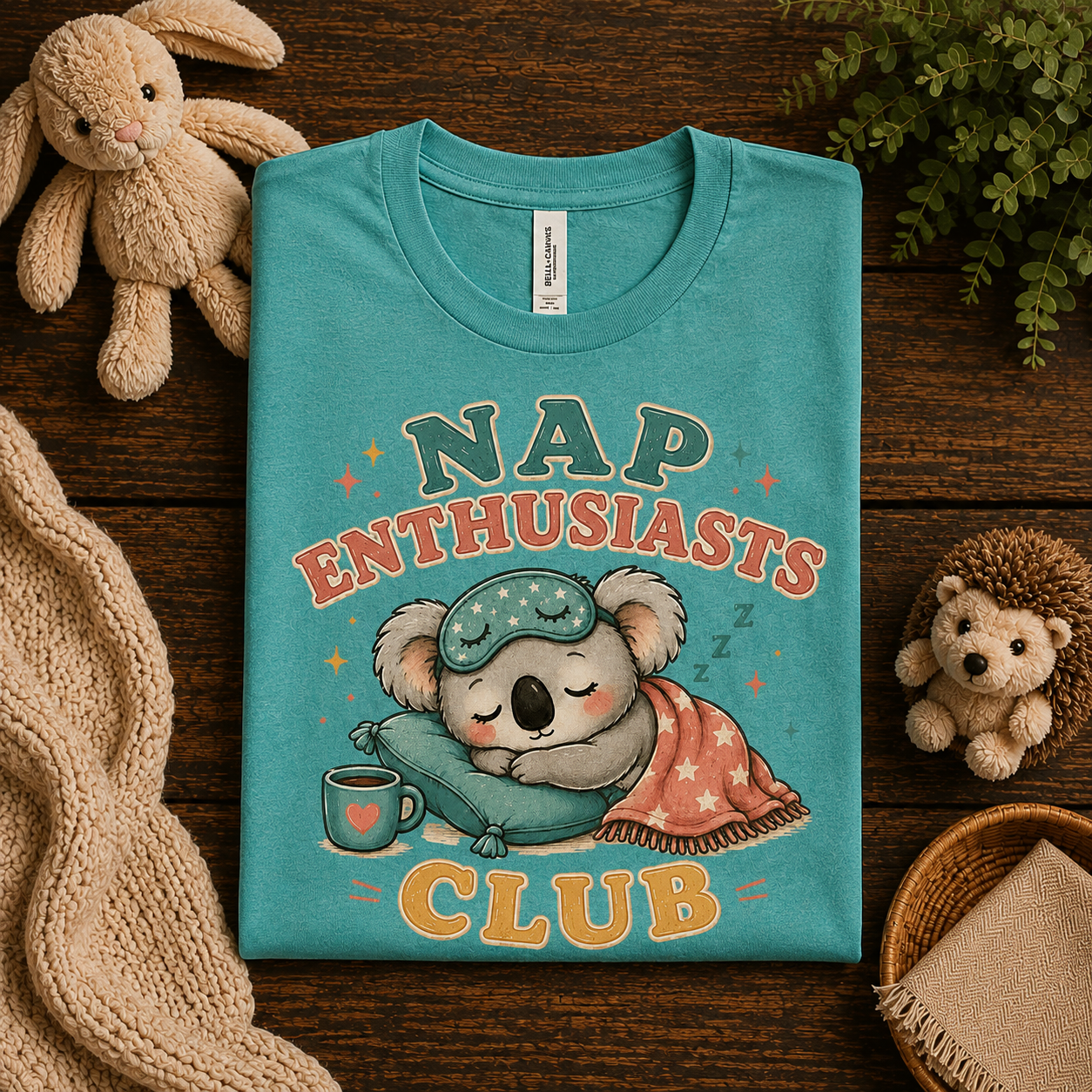 A folded mockup of Nap Enthusiasts Club graphic t-shirt in heather sea green.