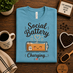 A folded mockup of Social Battery of Tea graphic t-shirt in aqua.